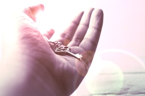 Hands holding a glowing key, illustrating unlocking potential and success