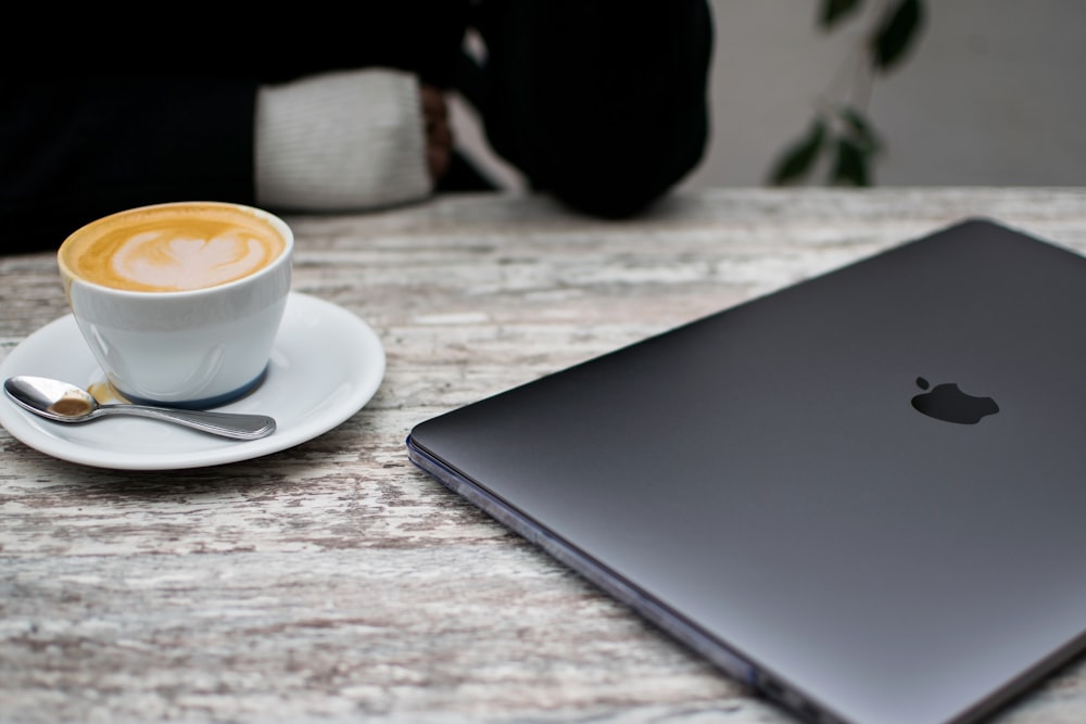 space gray MacBook beside serving of latter art