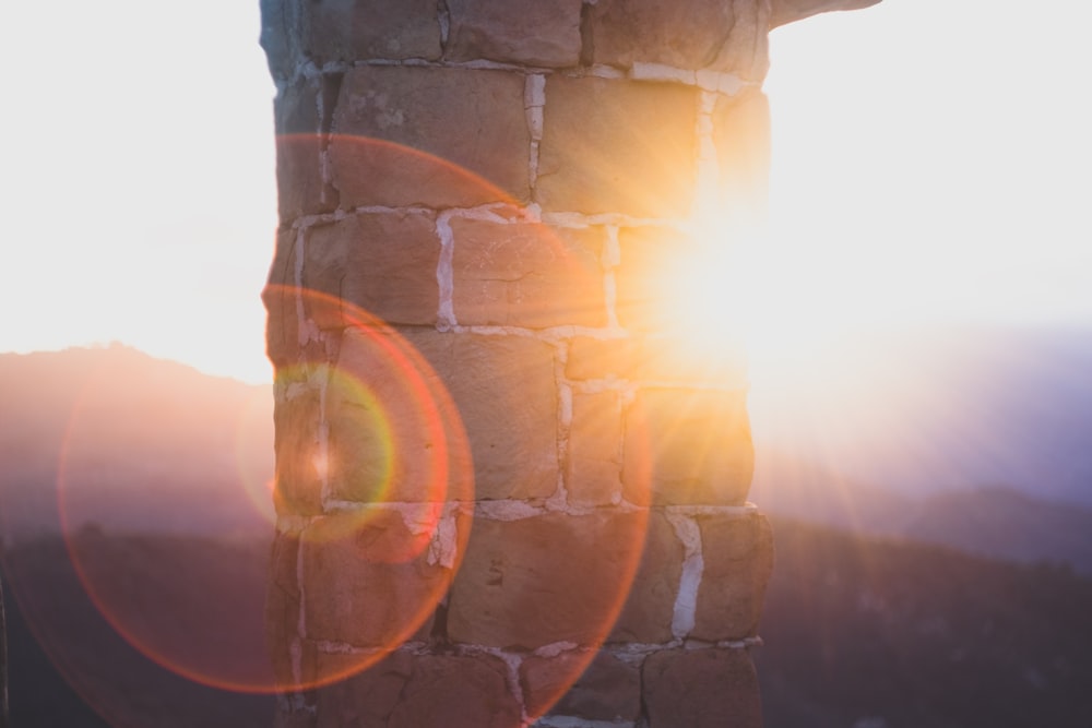 concrete bricked pillar with sunlight during daytime