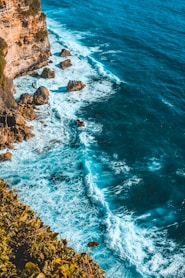 landscape photography of rock formation and body of water