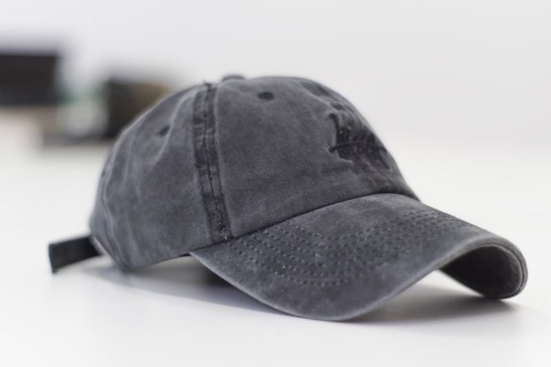 gray baseball cap on white surface