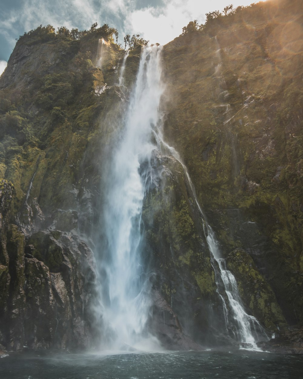 worm's-eye view of waterfall during daytime