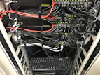 Close-up of high-speed internet cables neatly organized in a server rack.