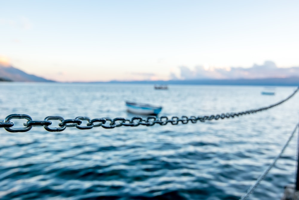 boat on sea water under sunny sky