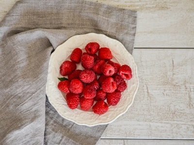 red berries on plate napkin teams background