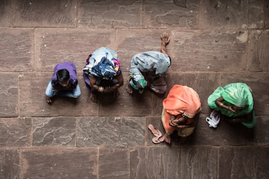 five person sitting on concrete floor in Orachha India