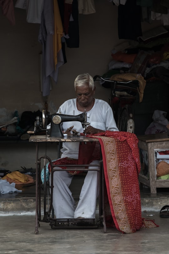 man using sewing machine in Orachha India