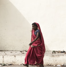 photo of woman walking on roadway