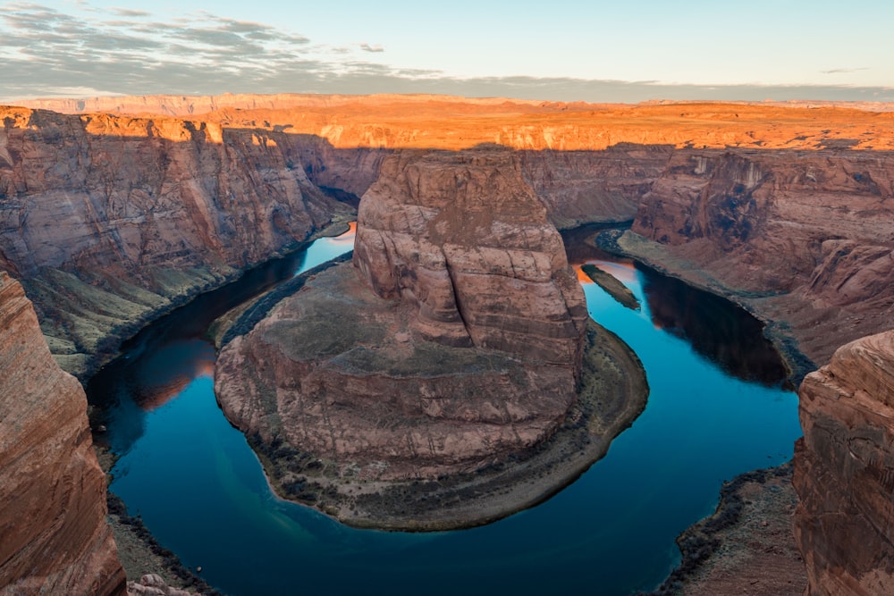 rock formation surrounded by body of water