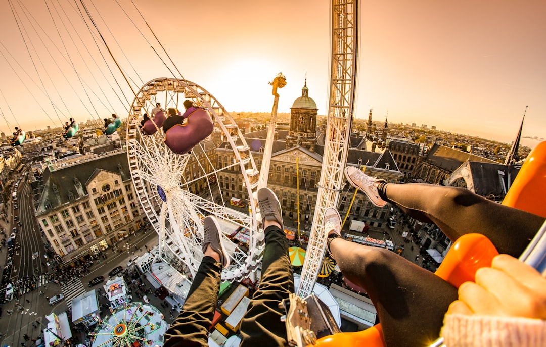 top view photo of ferriswheel, A view over the city of Amsterdam taken during the annual autumn carnival in Dam Square.