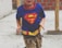 A happy child wearing a soft, sensory-friendly t-shirt with a bright superhero design.