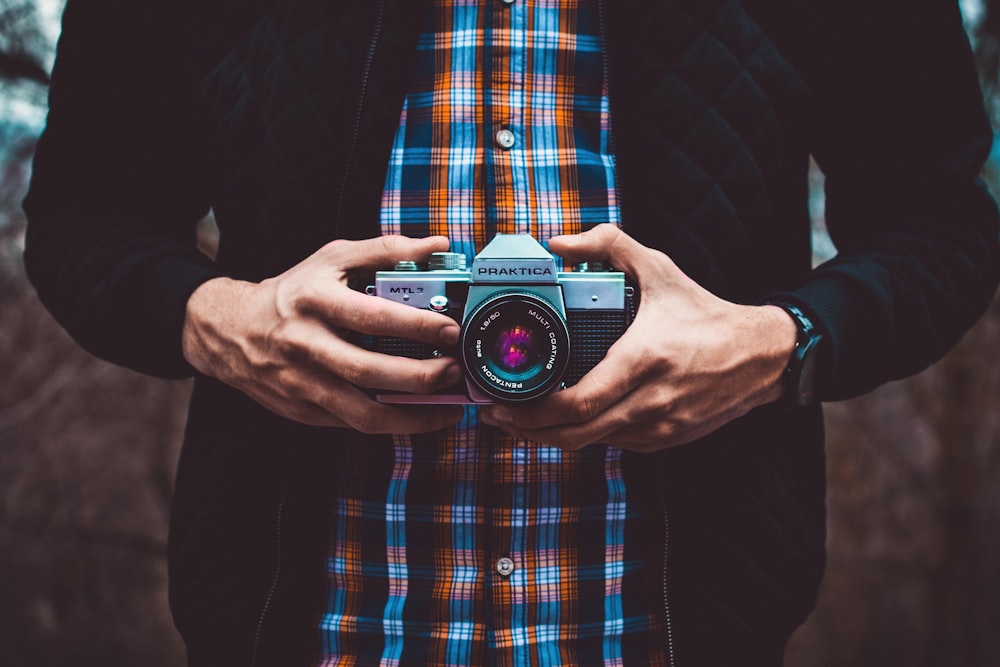 person holding mirrorless camera