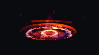 Close-up of a premium stainless steel cooktop glowing under soft kitchen lights.