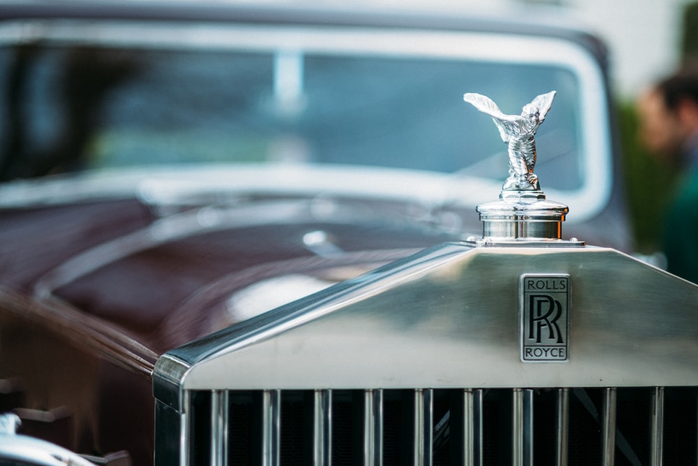 shallow focus photography of Rolls Royce emblem