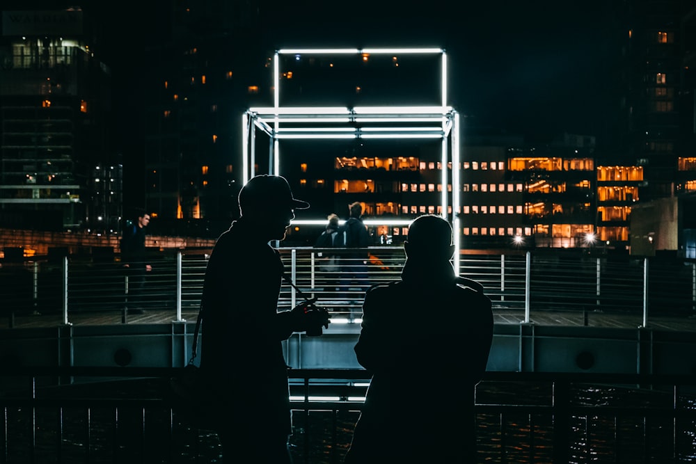 wo men talking in front of LED light frame