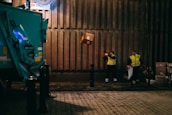 Warehouse workers loading packages onto a delivery truck, busy and focused.