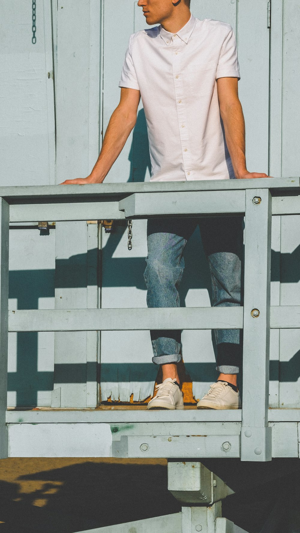 man standing in front of wooden fence