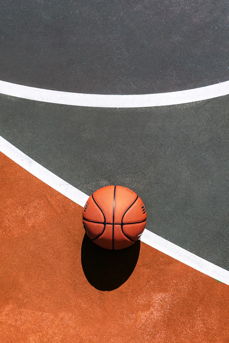 various sports equipment like a football helmet, hockey stick, and basketball - mouthguard for dental implants