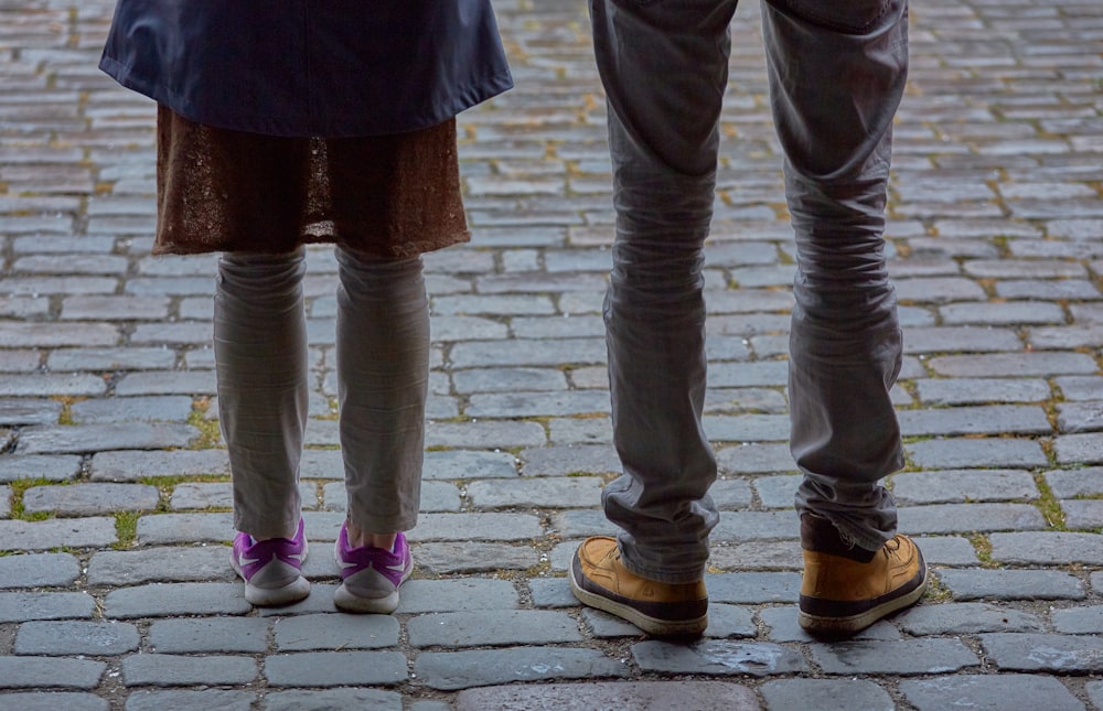 two person standing pavement