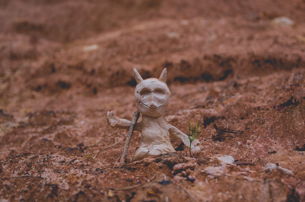 white figure beside green plant