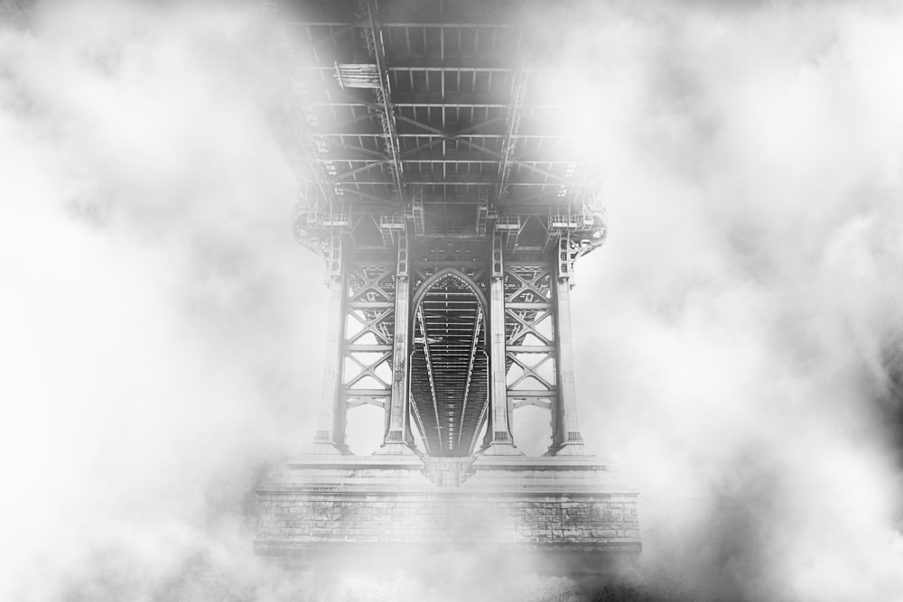 black truss bridge covered with fog digital wallpaper