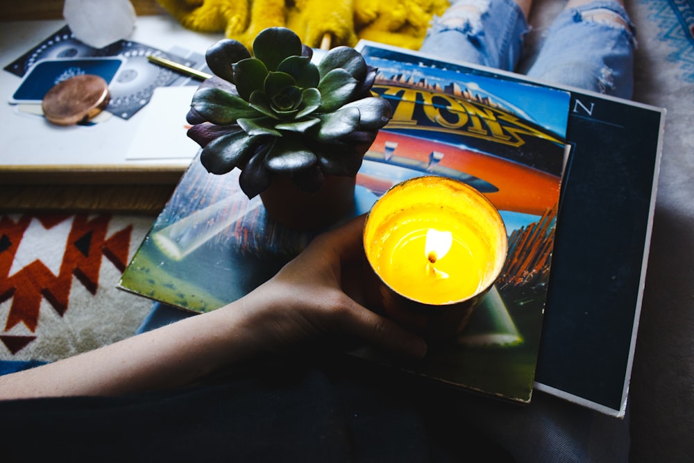 person holding tealight