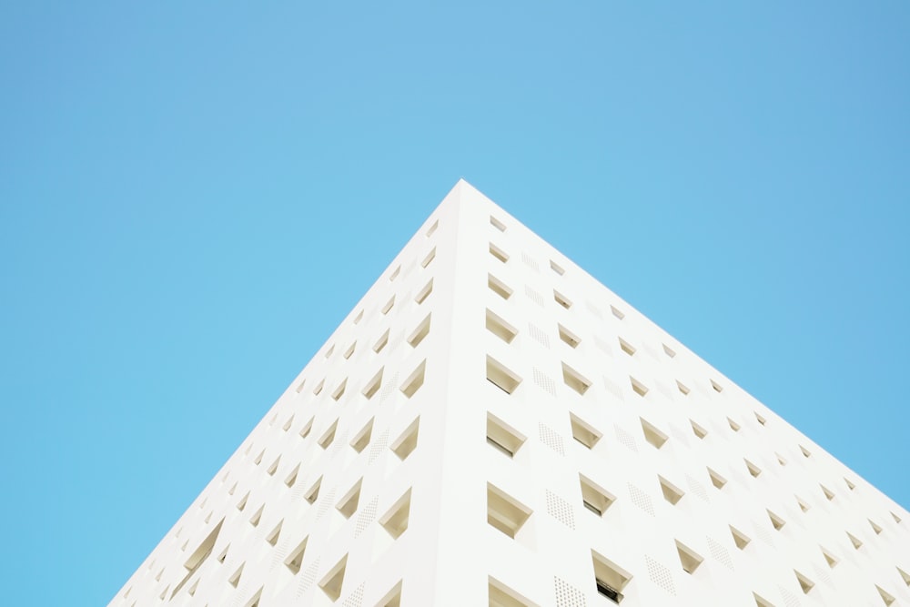 worm's eye view photography of white building under blue clear sky during daytime
