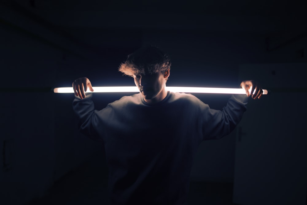 low light photography of man in gray sweatshirt