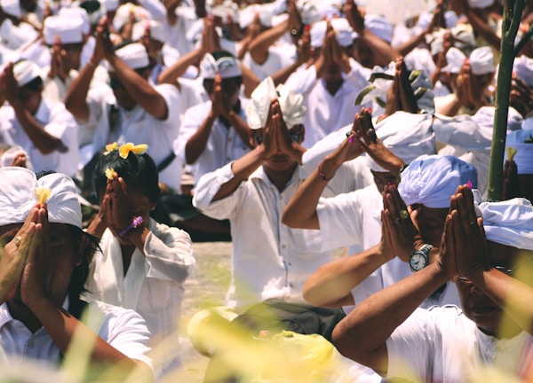 group of people worshipping outdoors