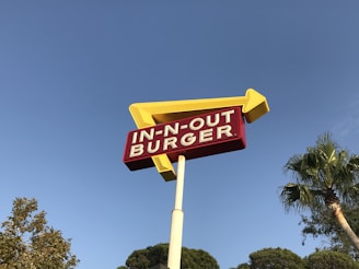 low-angle photo of In-n-Out Burger drive through signage