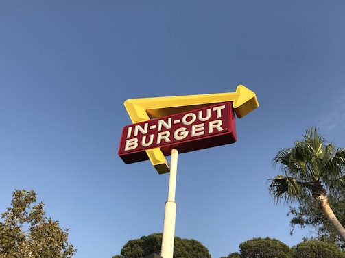 low-angle photo of In-n-Out Burger drive through signage