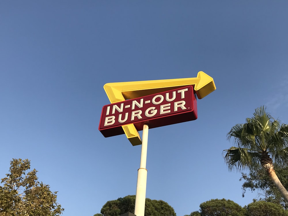low-angle photo of In-n-Out Burger drive through signage