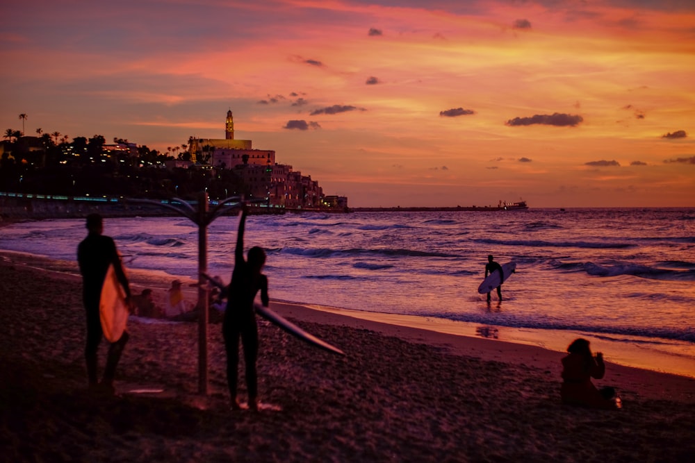 people holding surfboard