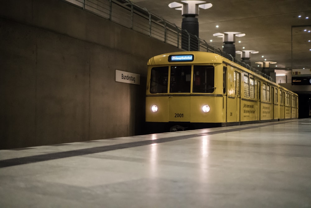 yellow electric train in station