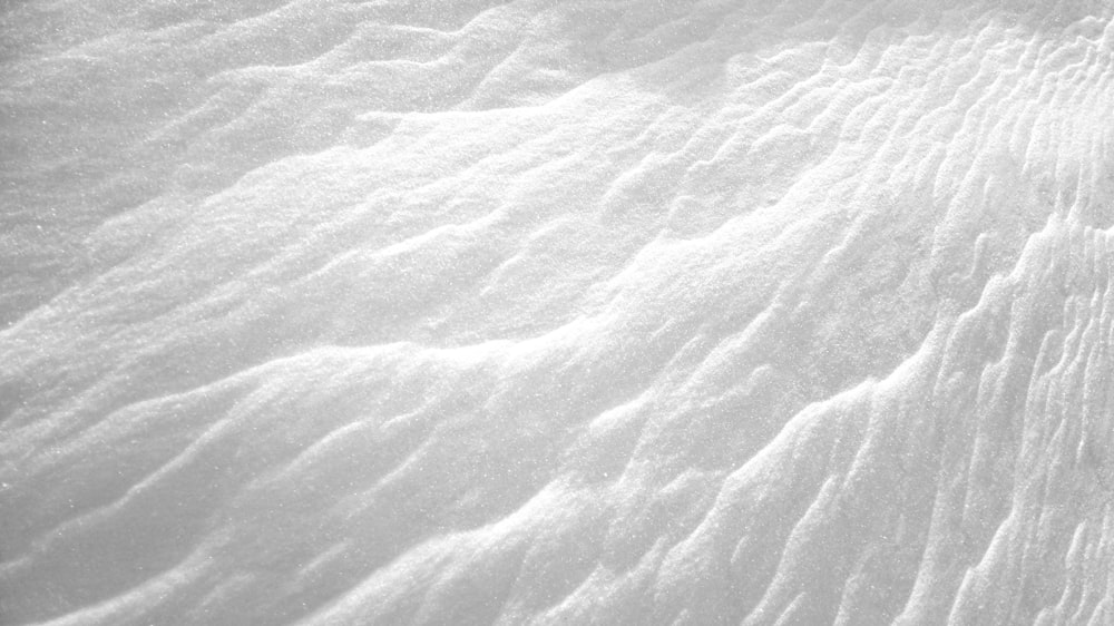 a person riding skis down a snow covered slope