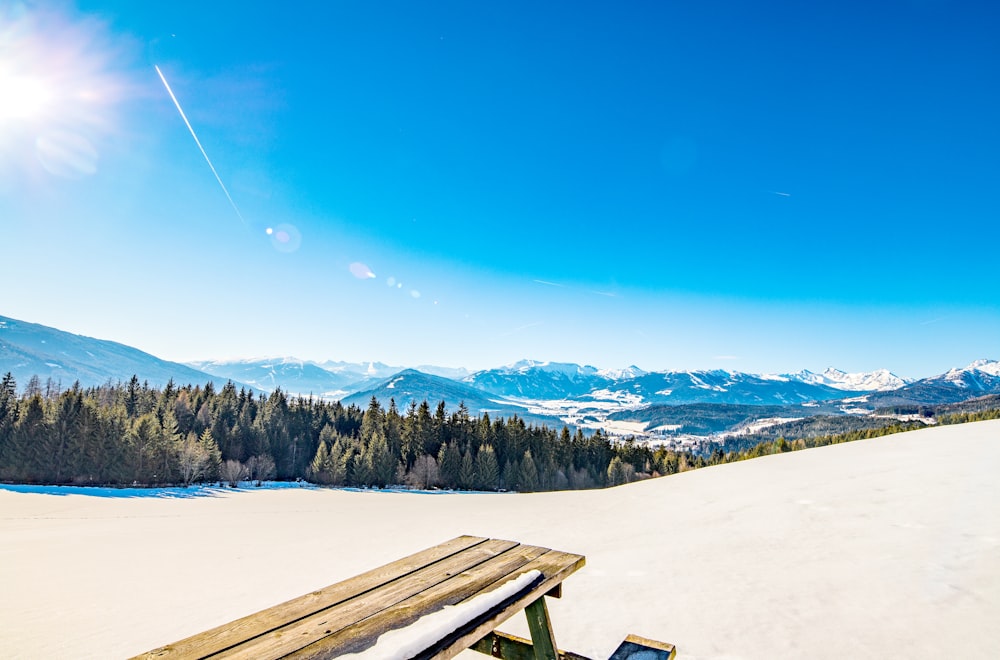 brown wooden snow sled on white snow field