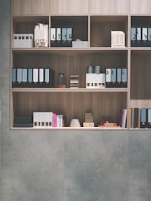 brown wooden shelf on grey wall