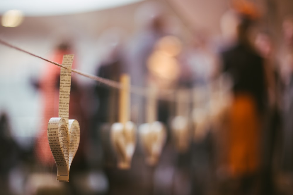 shallow focus photography of brown paper hanging outside