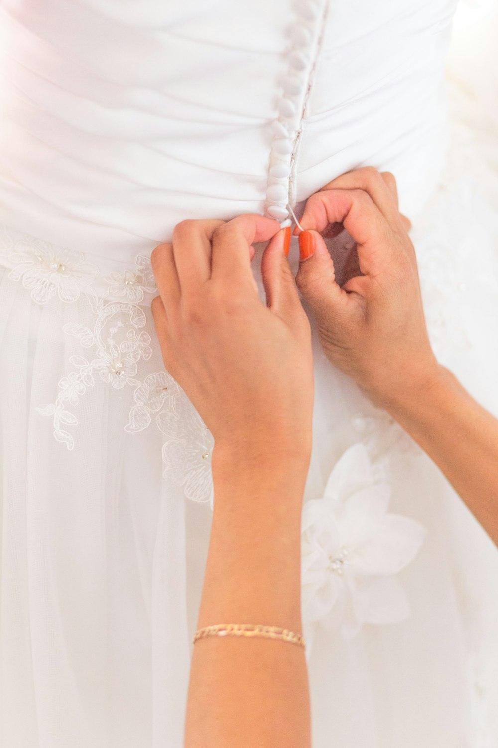 person holding white floral dress