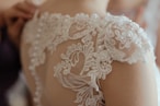 woman wearing white sheer lace wedding gown