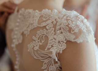 woman wearing white sheer lace wedding gown