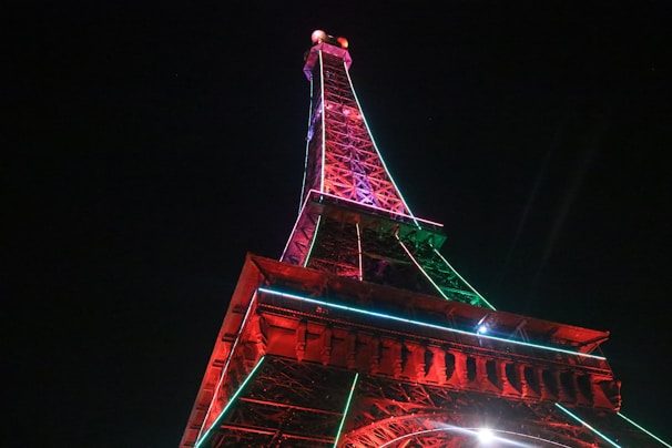 A night view of illuminated towers against a dark sky.