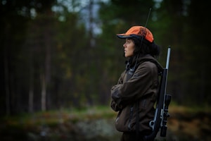 Hunting - hunter with rifle in woods