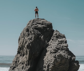 person standing at rock formation