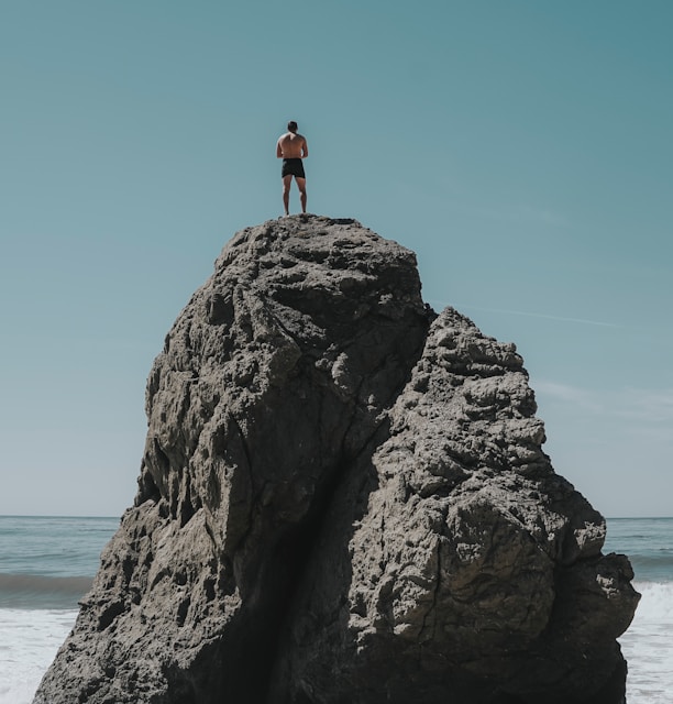 person standing at rock formation