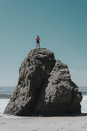 person standing at rock formation