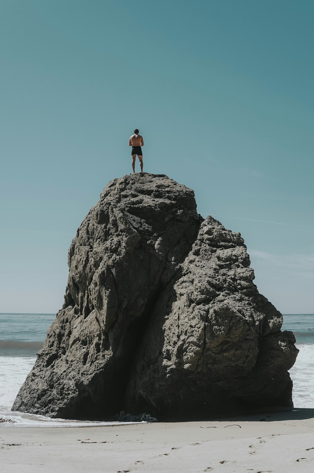 person standing at rock formation