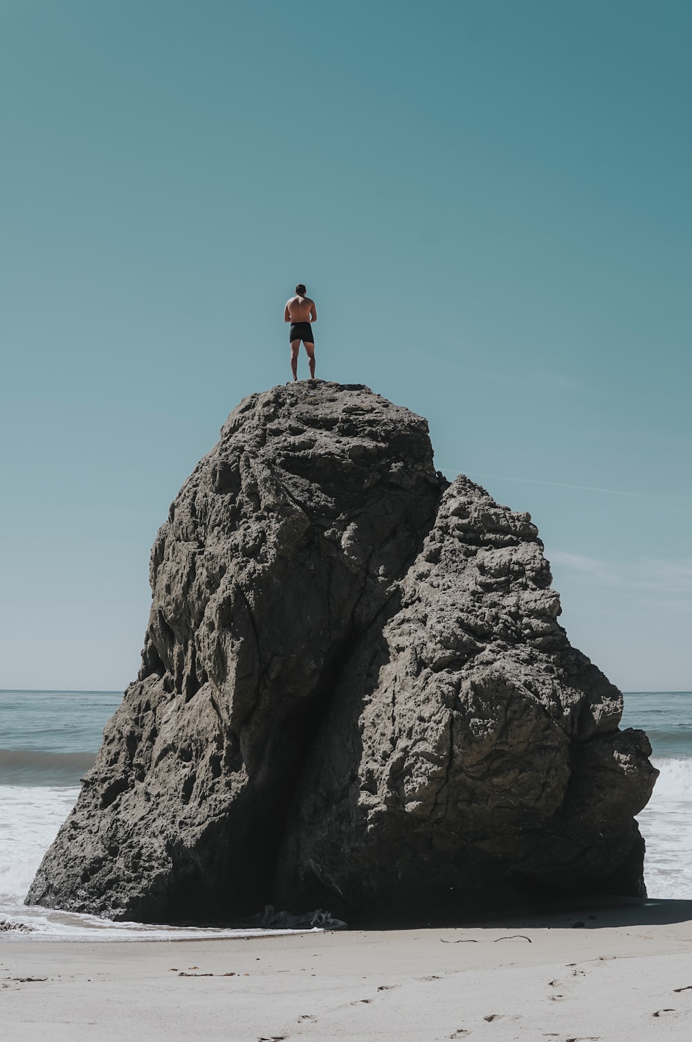 person standing at rock formation