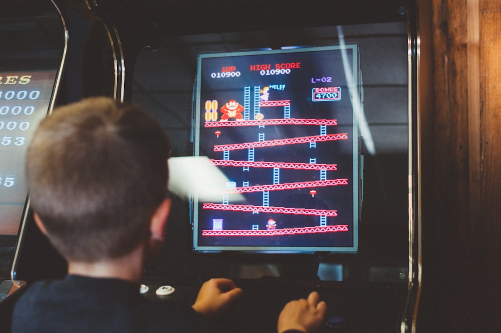 boy playing donkey kong arcade box