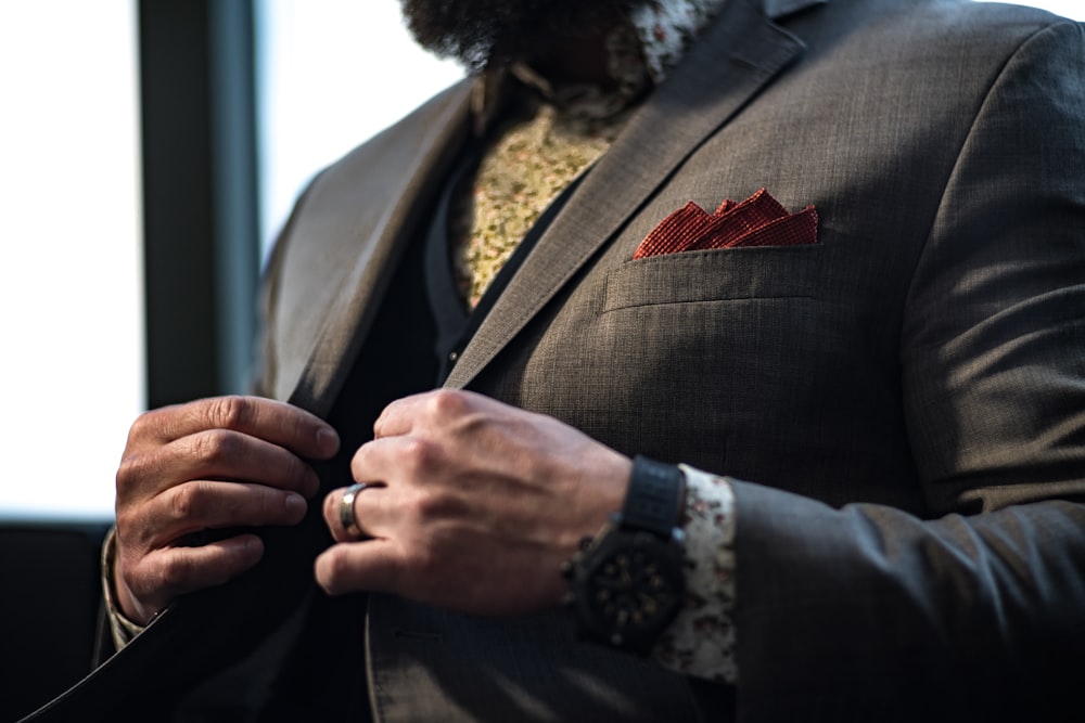 man wearing grey notched-lapel suit jacket